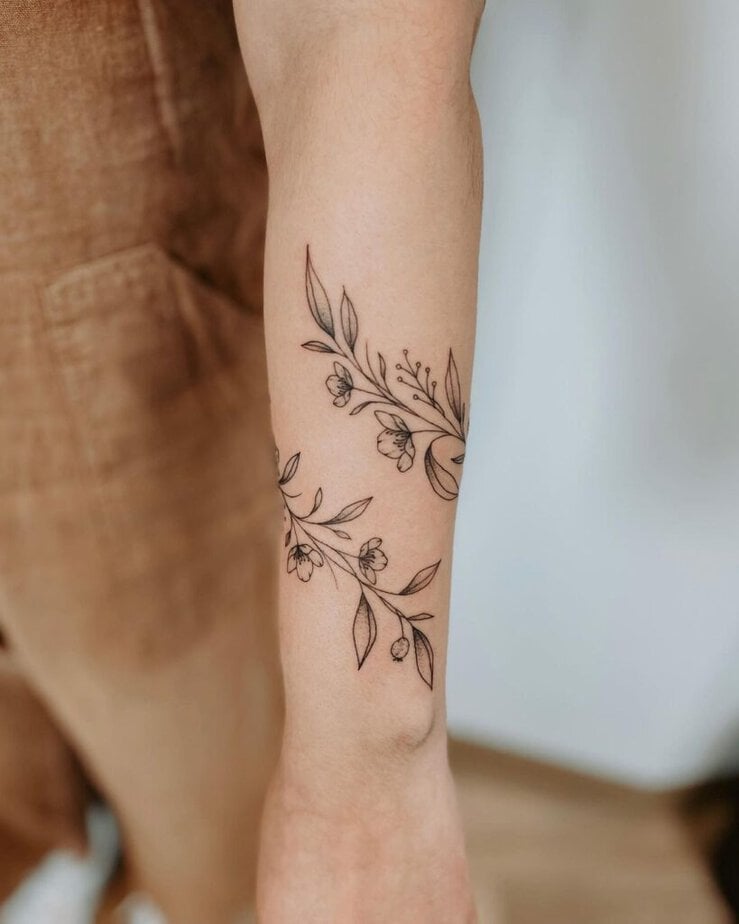 A floral wrist wrap tattoo