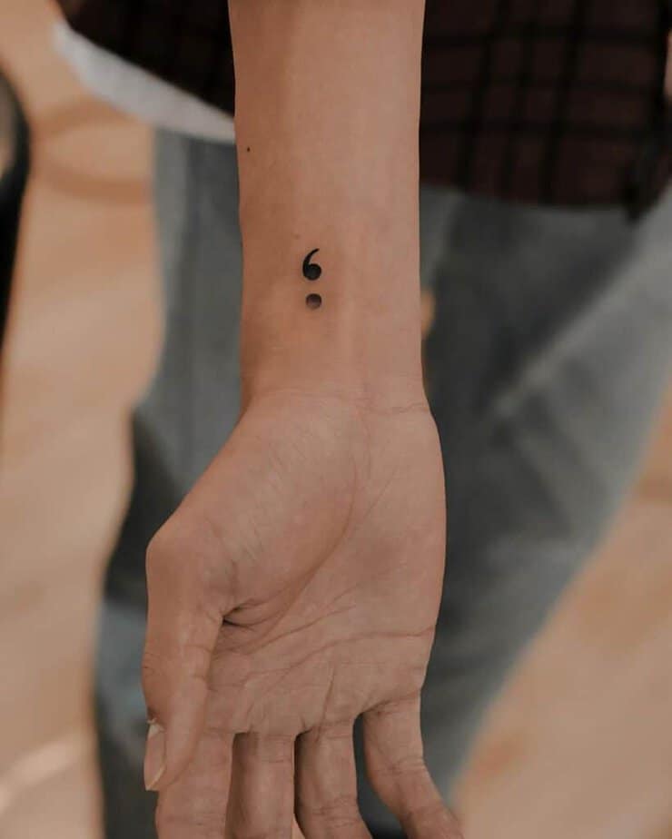 A semicolon wrist tattoo