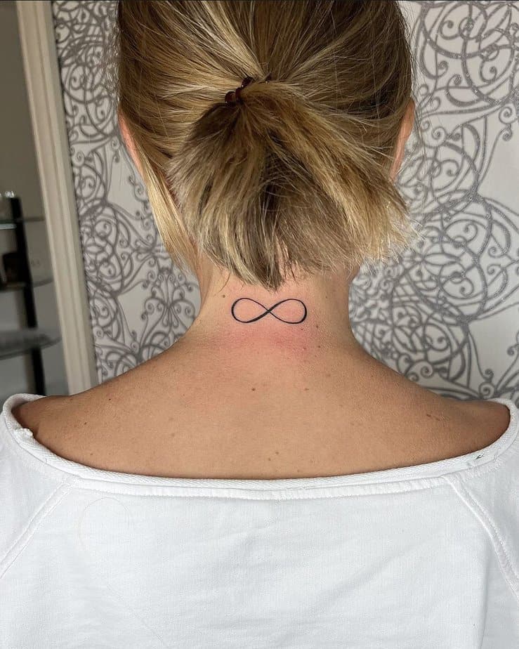 An infinity tattoo on the back of the neck