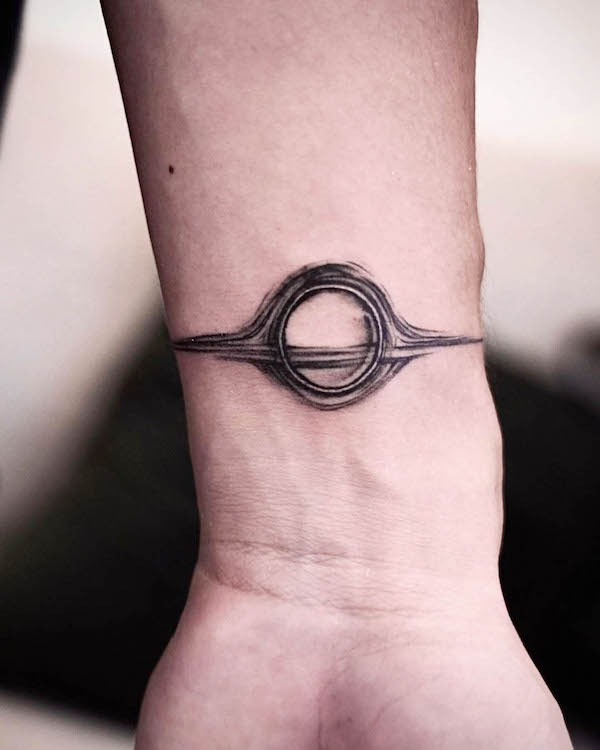 Black hole wrist tattoo