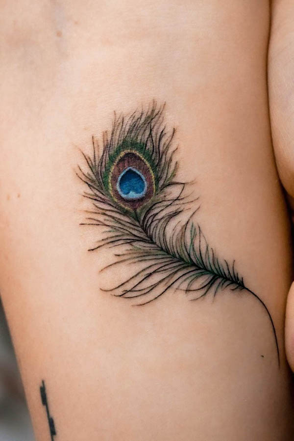 Detailed peacock feather tattoo