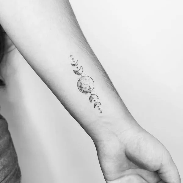 Feminine moon and leaves wrist tattoo