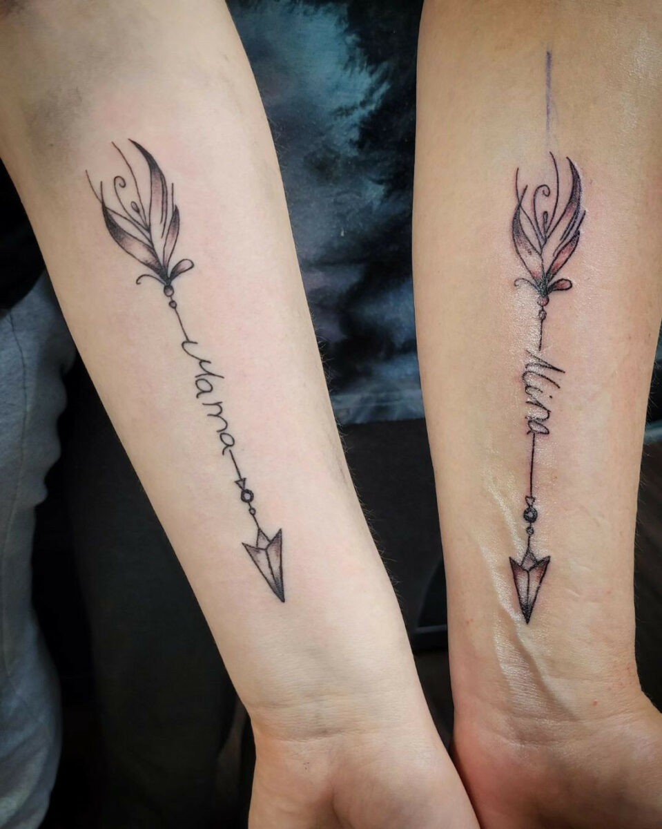 Matching arrow tattoos