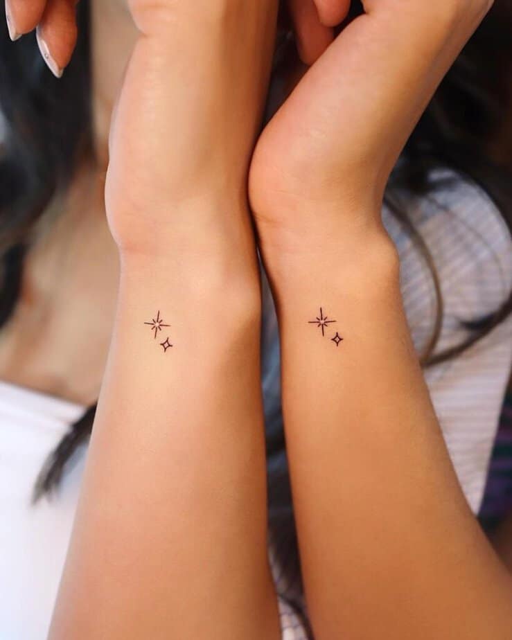 Matching wrist tattoos of sparkles