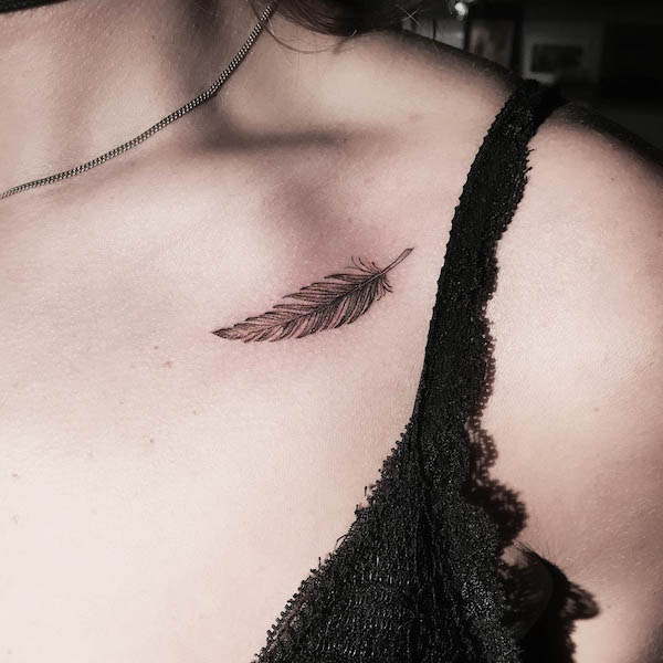 Small and simple feather collarbone tattoo