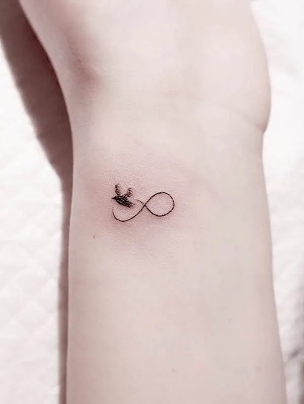 Small and simple infinity bird tattoo