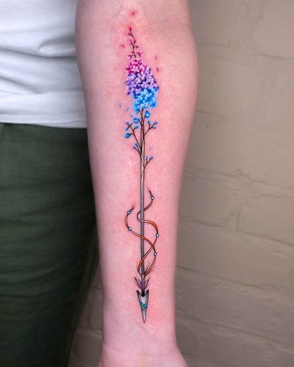 Whimsical watercolor arrow tattoo