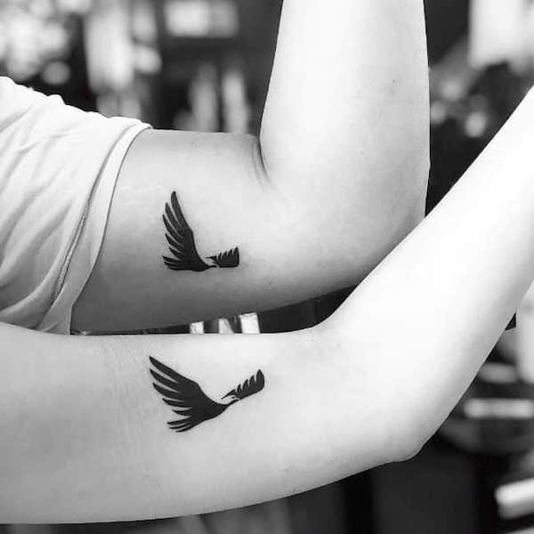 Matching bird tattoos on the arm