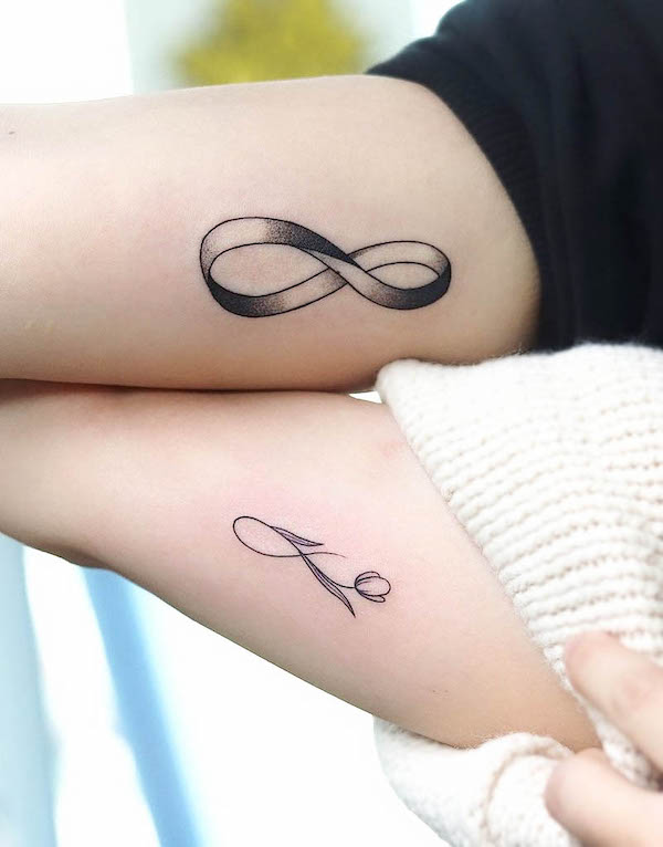 Matching infinity bicep tattoos