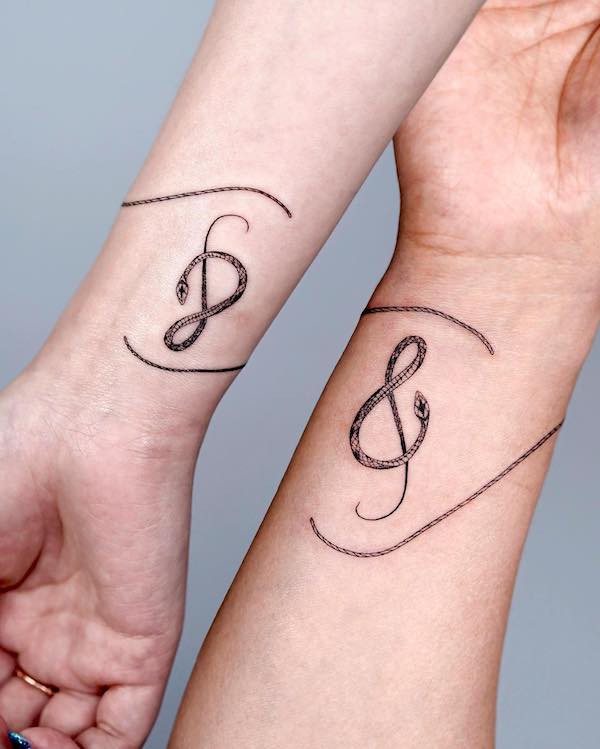 Matching snake music tattoo