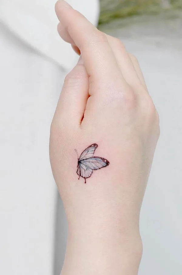 Small crystal butterfly hand tattoo