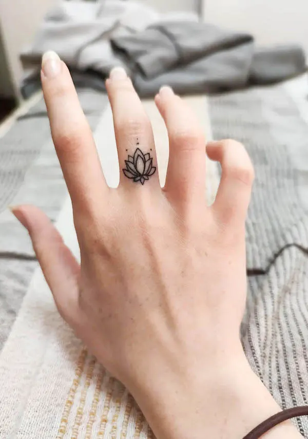 Small lotus middle finger tattoo