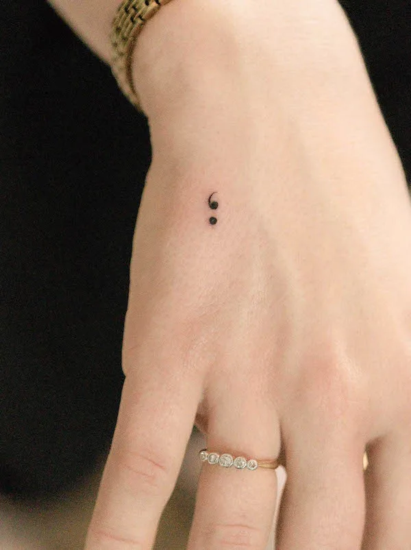 Tiny semi-colon tattoo