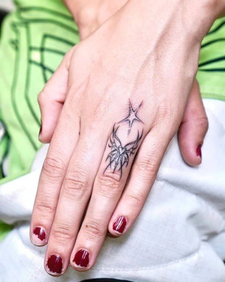 A Cybersigilism butterfly finger tattoo