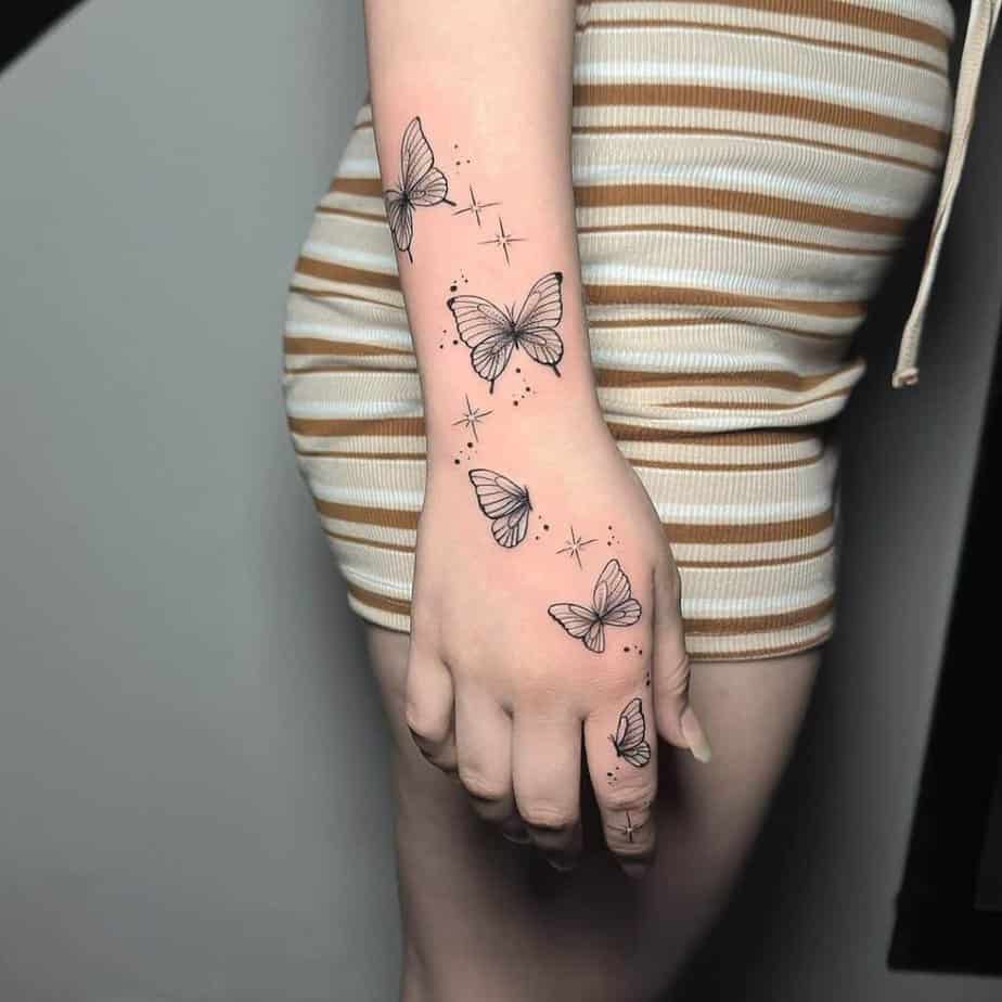 A butterfly tattoo with dots and sparkles