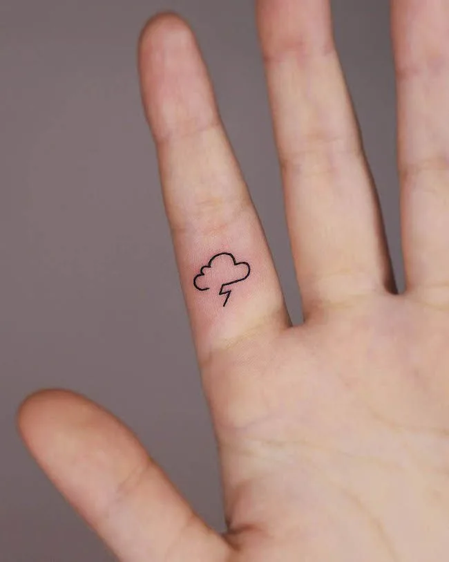 A dainty storm finger tattoo