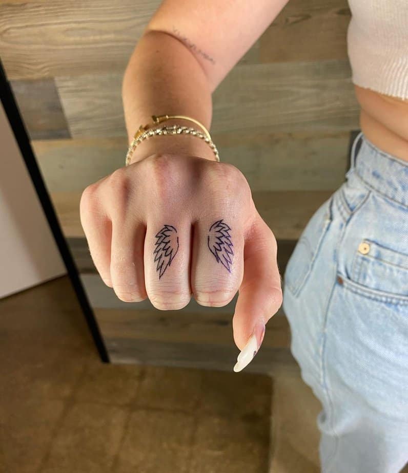 A tattoo of wings on your fingers