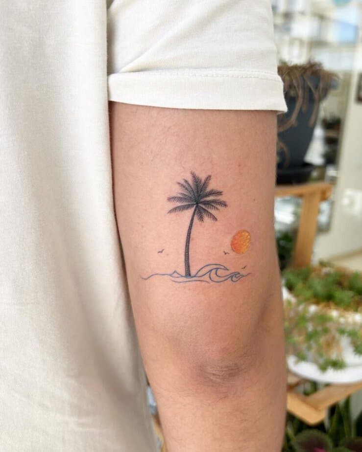 A colorful palm tree scene tattoo