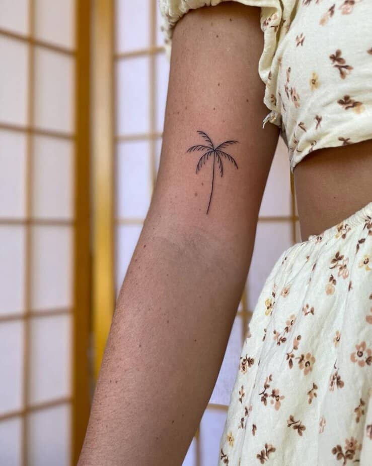 A fine-line palm tree tattoo