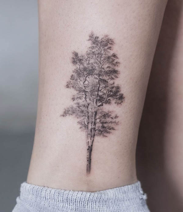 Black and grey birch tree arm tattoo